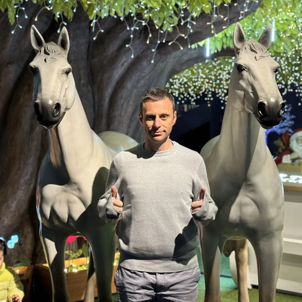 Me with two plastic horses giving thumbs up.